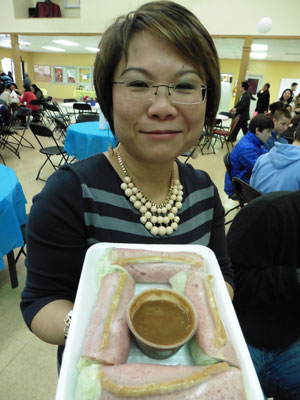 Hang Nguyen offers salad rolls