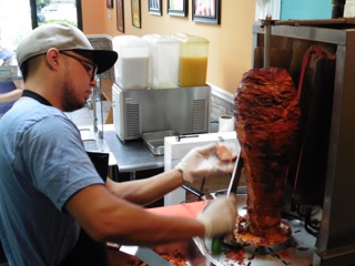 Alberto Turuda slices pork from the trompo spit.