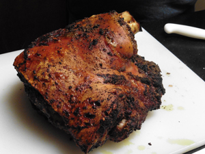 A sofrito rub gives the roast pork a leathery, crunchy exterior called cuero.