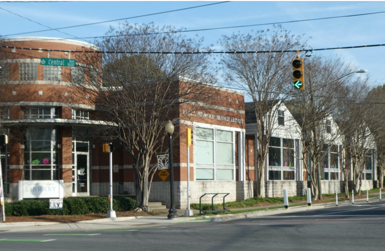 Architecturally, this is one of the county's most delightful branch libraries. The main brick section honors the corner, while the rear portion has wood siding and gable roofs to blend with the houses of The Plaza. Charlotte architect Pat Campbell of LS3P Associates designed it in 1996.