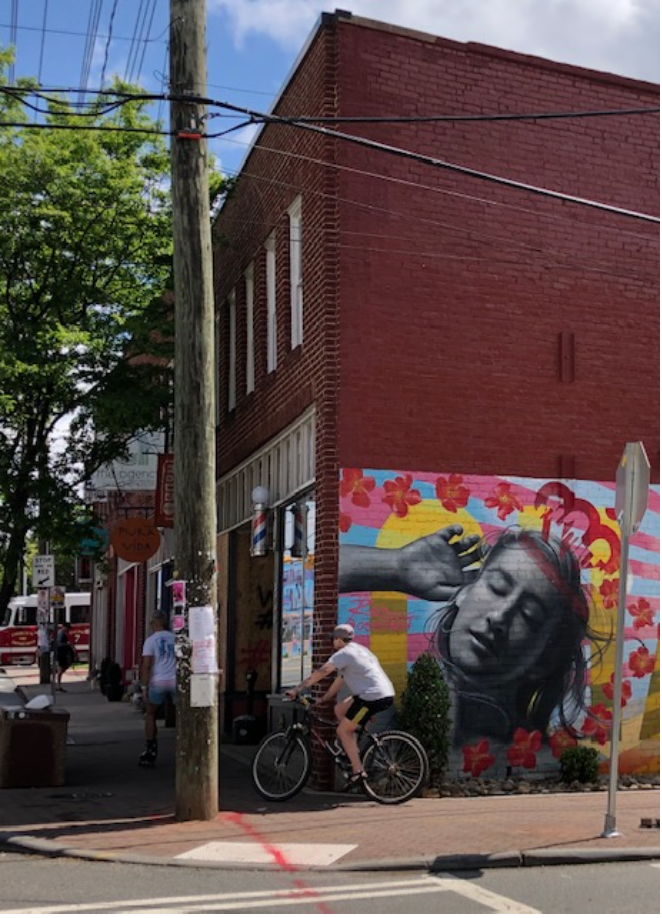 Look to your left at the 35th Street intersection to see the wall art by Osiris Rain, who paints murals for clients internationally from a base in Charlotte. Artistic energy runs deep right here. Claymaker Paul Sires and painter Ruth Ava Lyons rebuilt this row of shops to make space for their Center of the Earth Gallery, now gone but not forgotten.