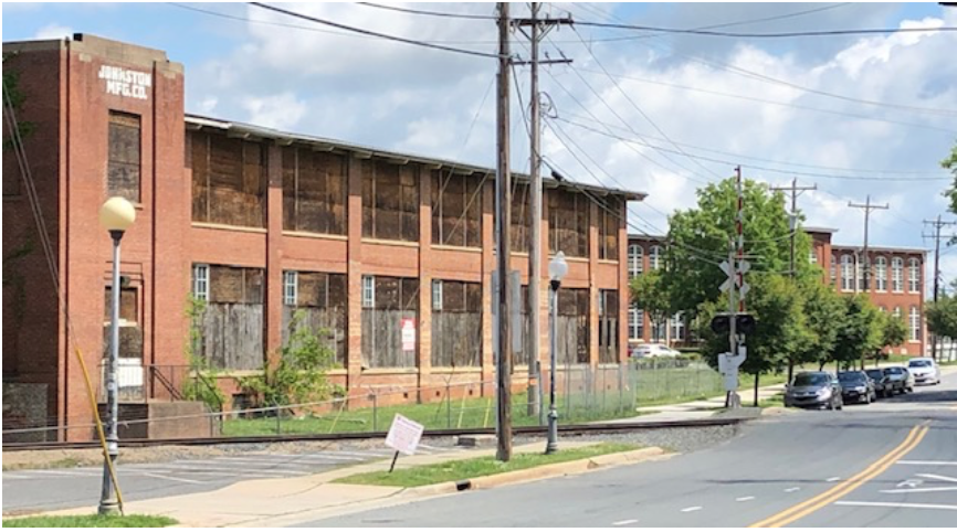 The Johnston family opened this spinning mill in 1916. As textile production began moving out of the U.S. after WWII, chasing ever-cheaper labor, the Johnstons hung on as long as they could. “Charlotte Losing Last Major Textile Plant: Johnston Manufacturing Co. is permanently closing its N. Davidson Street operation” reported the Charlotte Observer on March 1, 1975. After an attempt at rehab as apartments, the long-vacant structure today again awaits a visionary developer.