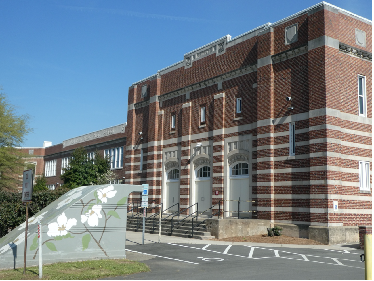 Built back in 1925, when junior high schools were a new thing. Charlotte spared no expense -- handsome brick and stone work, even an underground tunnel (can you see its entrance, art-ified with painted dogwood flowers?) to get students across 10th Street safely. Today junior highs are “middle schools” and Piedmont remains a much-sought-after magnet.