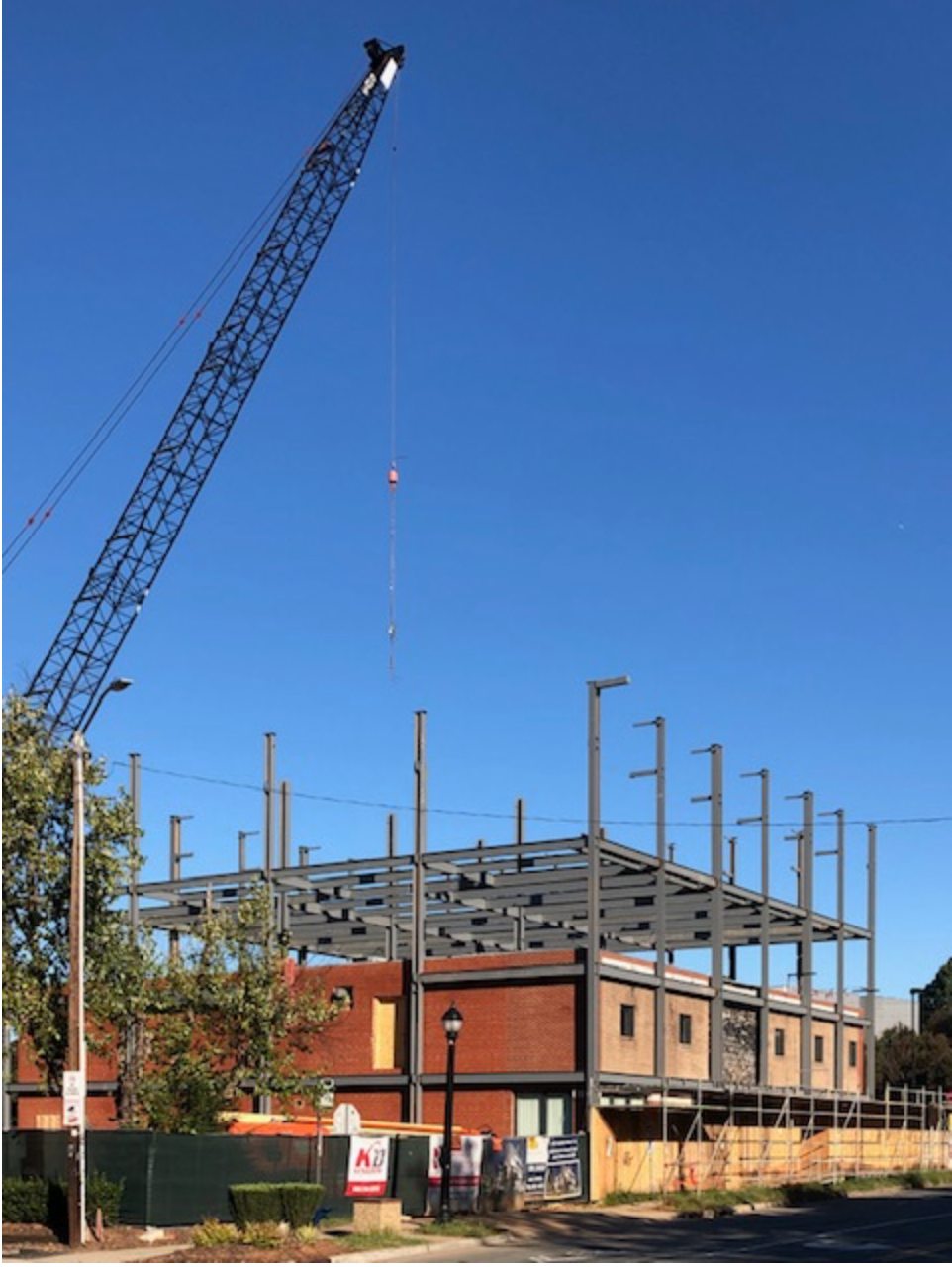 Such a symbol of this changing neighborhood! Originally a furniture store serving 1950s suburbanites, it sat empty in the 1990s before being rehabbed as a Post Office. Today, with land values soaring, it’s soaring upward, too. A new steel structure added in 2020 - 21 enlarged it from two to four stories — while the Post Office stayed open.