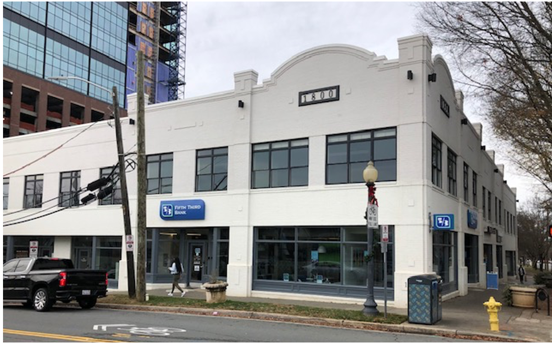 This two-story brick row looks older, but it dates from 1999. After chasing suburban dreams, Americans were beginning to rediscover the joys of urban living. Developer Tony Pressley took a chance on constructing these small retail units with living space upstairs. A success!